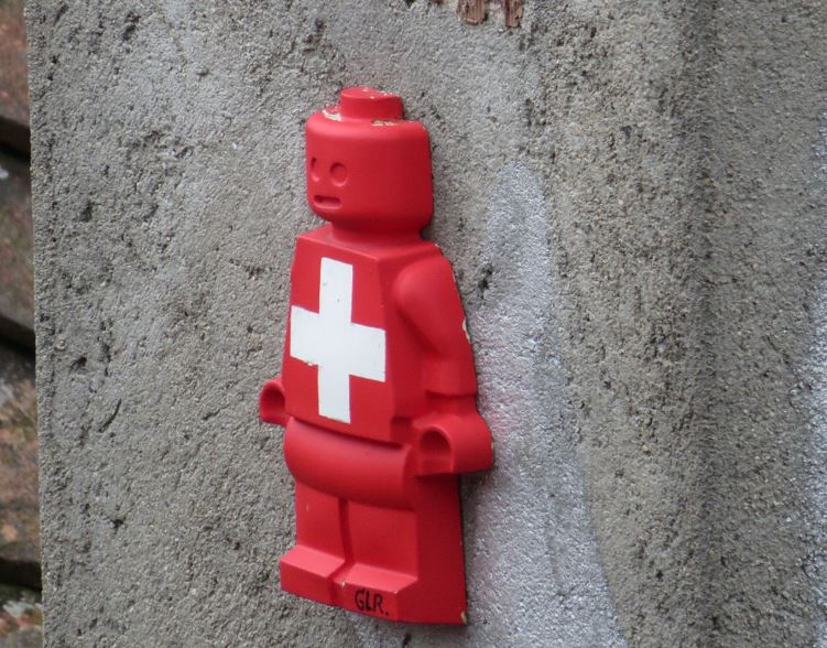 Lego character with Swiss flag on wall - Credit: chaoticjourney.com