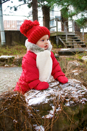 A baby girl in her snow suit and a warm hat in Canada © tatykud - Fotolia.com
