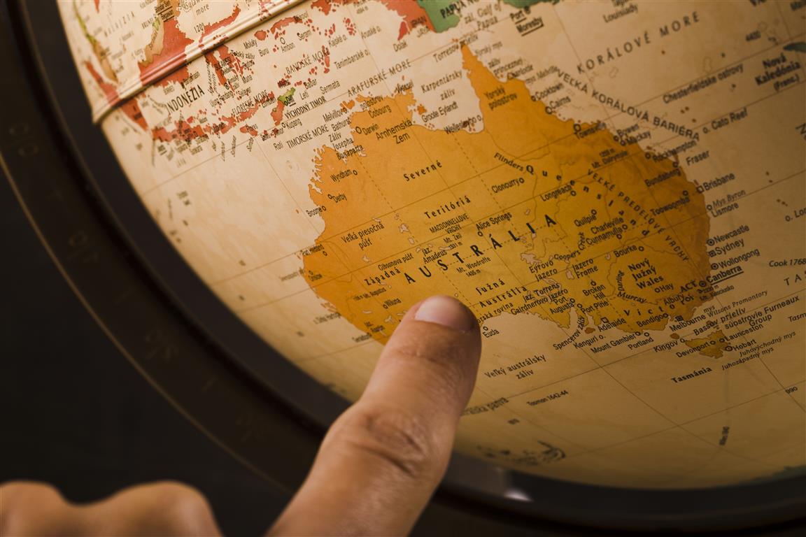 Pointing at Australia on a globe - People photo created by freepik - www.freepik.com