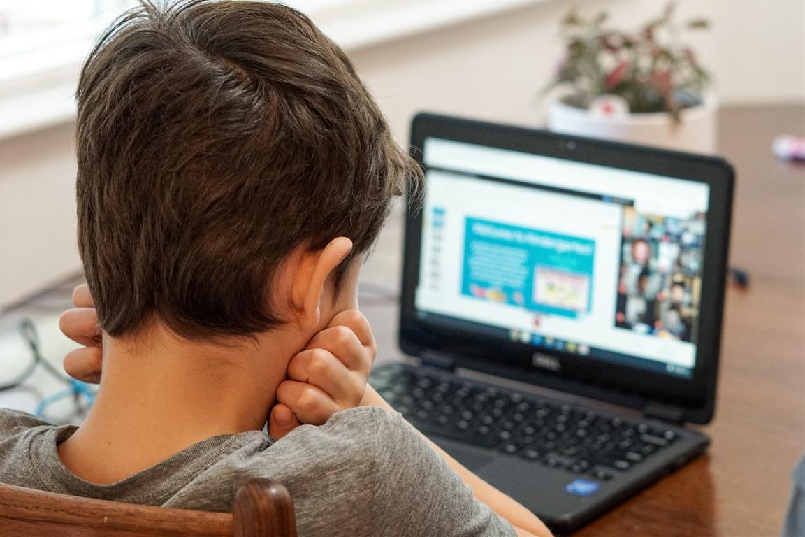 Boy looking at laptop computer during first day of virtual learning - Photo by Thomas Park on Unsplash